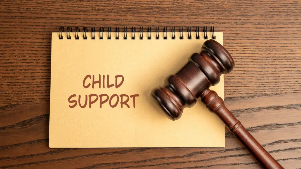 Notebook reading "Child support" with a gavel