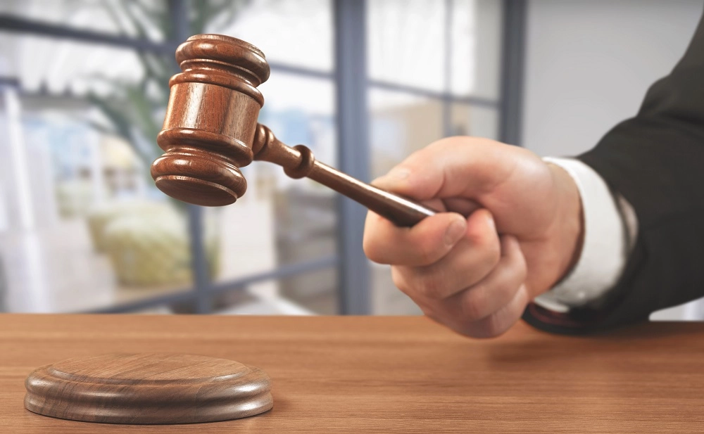Judge's hand bringing down a gavel