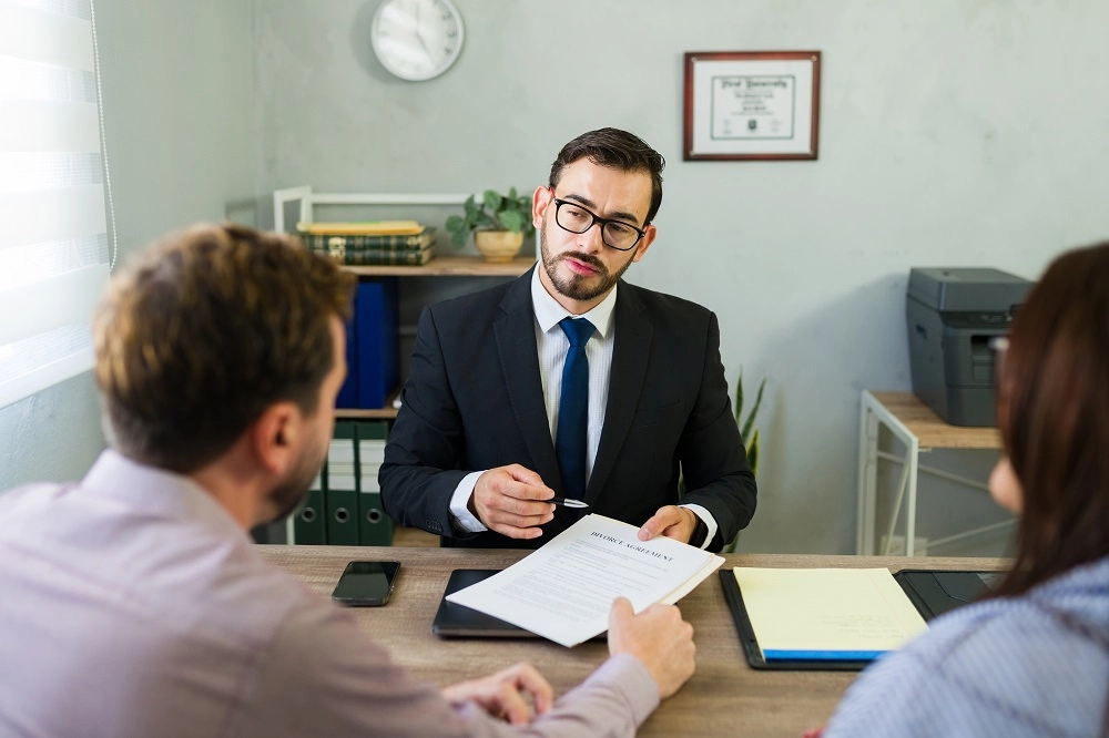 Couple meeting with a lawyer across his desk