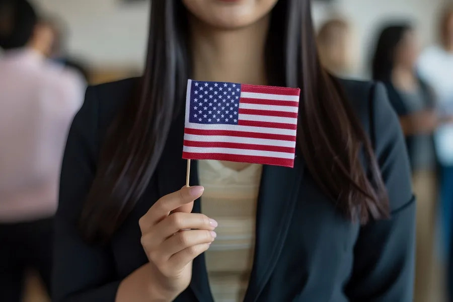 Woman holding a small American flag