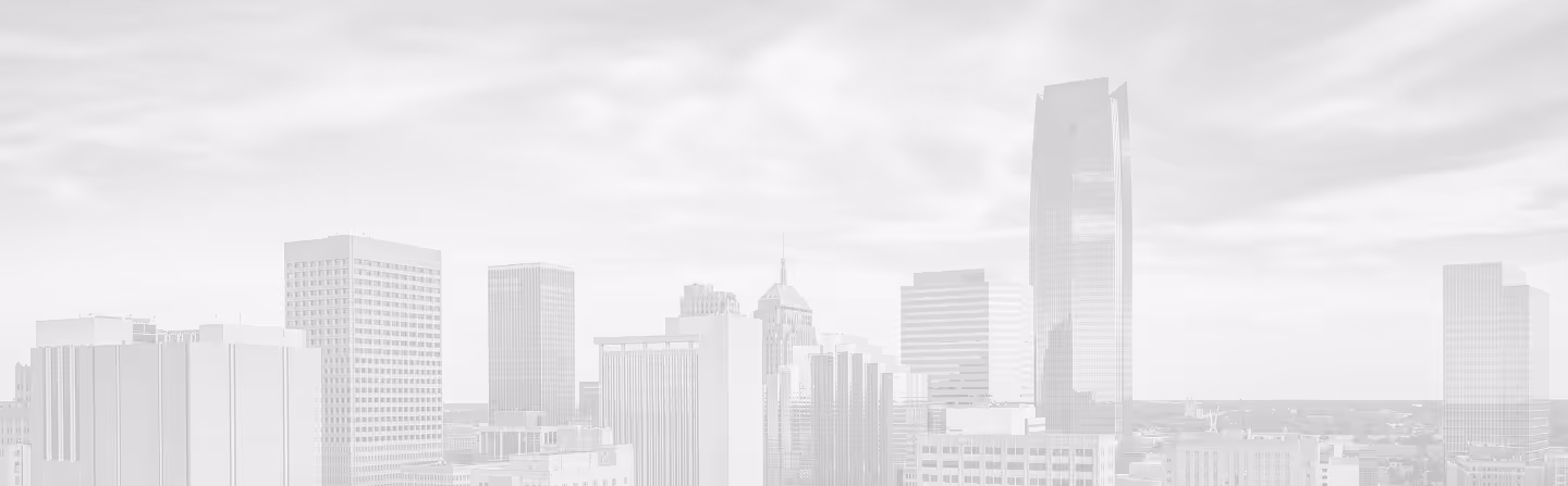 City skyline with various tall buildings under a cloudy sky.
